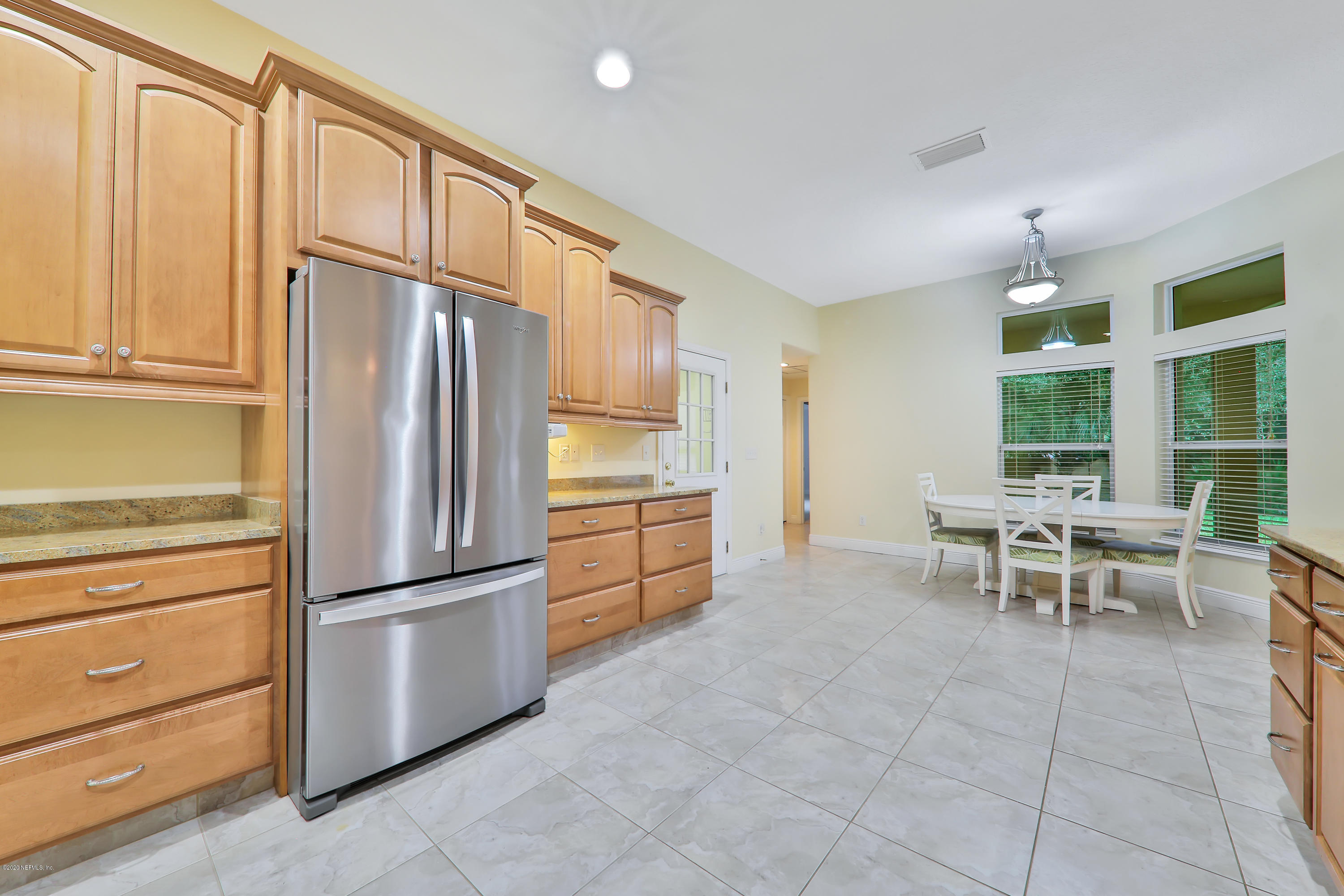 3289 Kings Road South St. Augustine, FL 32086 - Photo 6 of 41 a kitchen with granite countertop cabinets and refrigerator