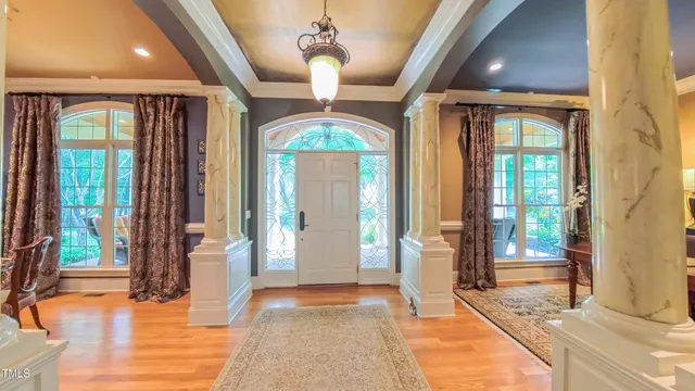 a view of a dining room with furniture large windows and wooden floor