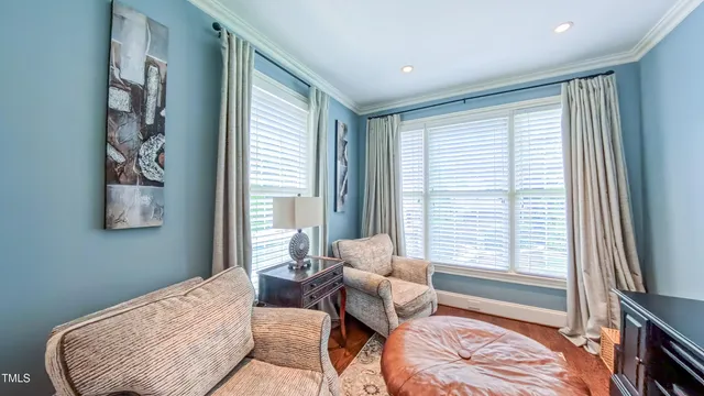 a living room with furniture a flat screen tv and kitchen view