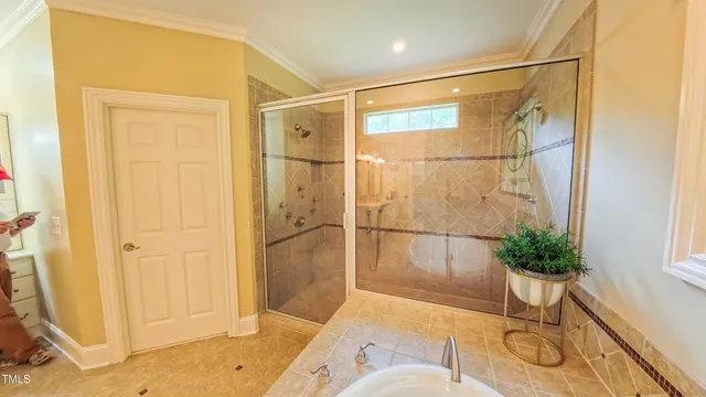 a view of a house with a yard and large tree