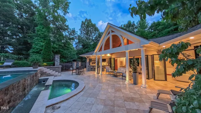 a front view of a house with a yard porch and outdoor seating