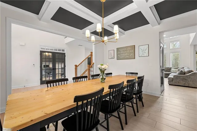 a living room with stainless steel appliances kitchen island granite countertop a refrigerator and cabinets