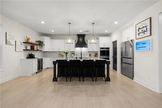 a spacious bedroom with a bed a walk in closet and a couch