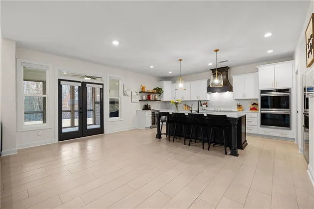 a spacious bedroom with a bed and a chandelier