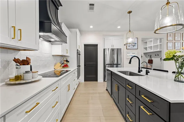 a en suite bathroom with a bathtub and 2 sink