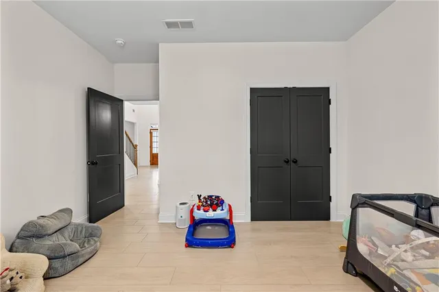a bathroom with a granite countertop sink a toilet a mirror a bathtub and shower