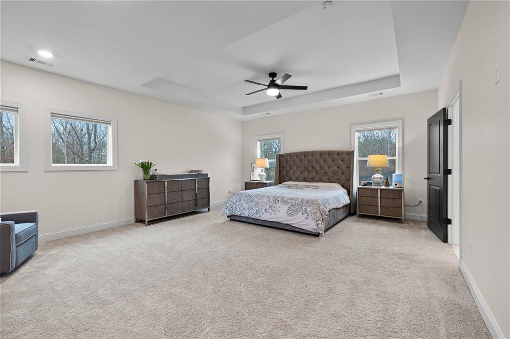 4895 Cool Springs Road Winston, GA 30187 - Photo 40 of 85 a spacious bedroom with a bed a walk in closet and a couch