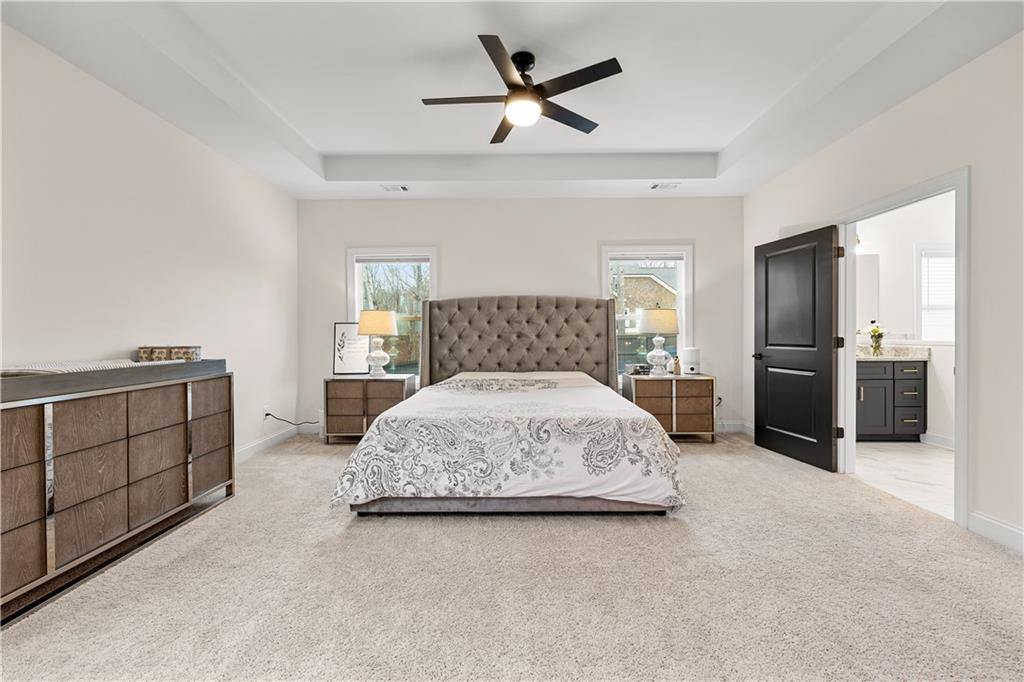 4895 Cool Springs Road Winston, GA 30187 - Photo 41 of 85 a spacious bedroom with a bed and a chandelier