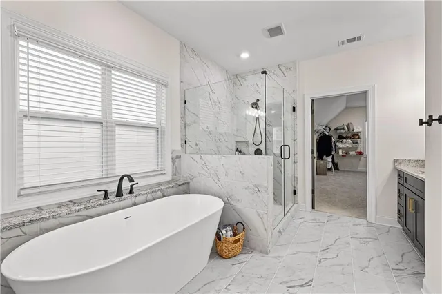 a living room with a fireplace furniture and a large window