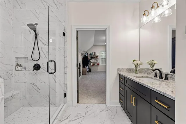 a bathroom with a granite countertop shower and a mirror