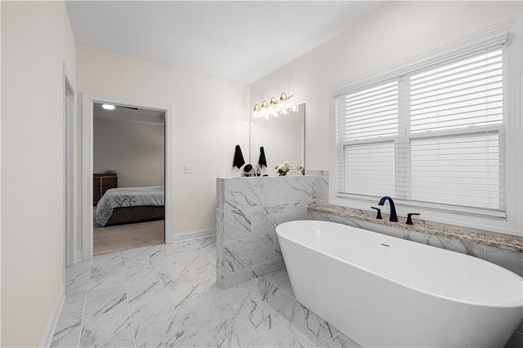4895 Cool Springs Road Winston, GA 30187 - Photo 49 of 85 a en suite bathroom with a bathtub and 2 sink