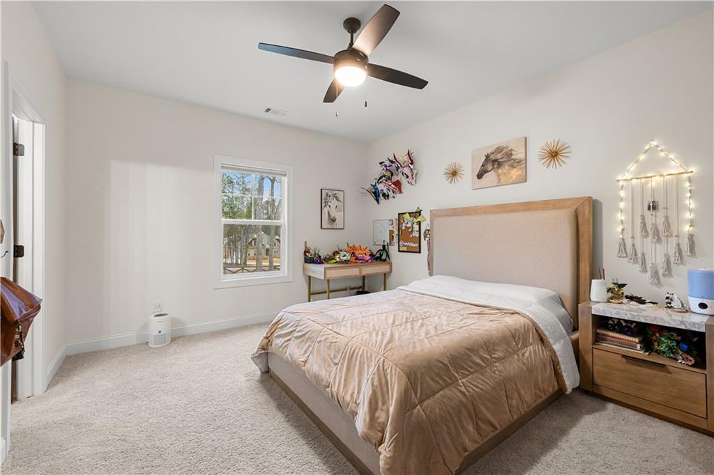 4895 Cool Springs Road Winston, GA 30187 - Photo 51 of 85 a bedroom with a large bed and a chandelier