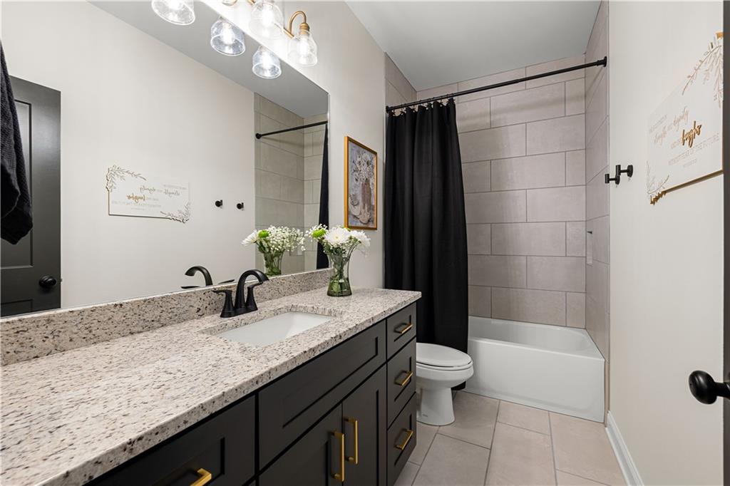 4895 Cool Springs Road Winston, GA 30187 - Photo 54 of 85 a bathroom with a granite countertop sink a toilet a mirror a bathtub and shower