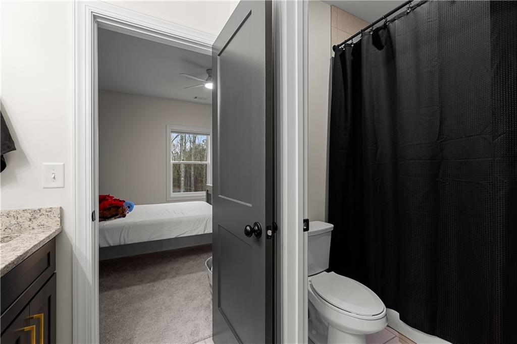 4895 Cool Springs Road Winston, GA 30187 - Photo 62 of 85 a en suite bathroom with a granite countertop sink toilet and shower