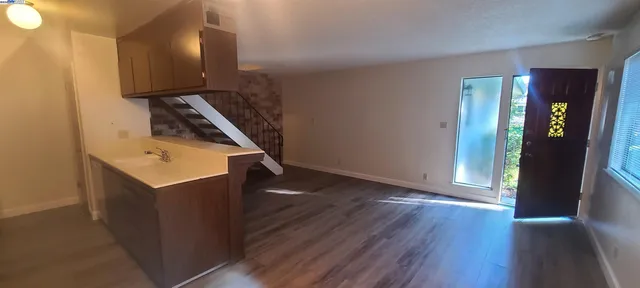 a view of an entryway with wooden floor