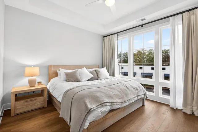 a bedroom with a bed and a large window