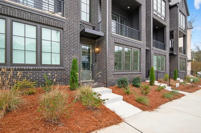 a view of a brick house with many windows