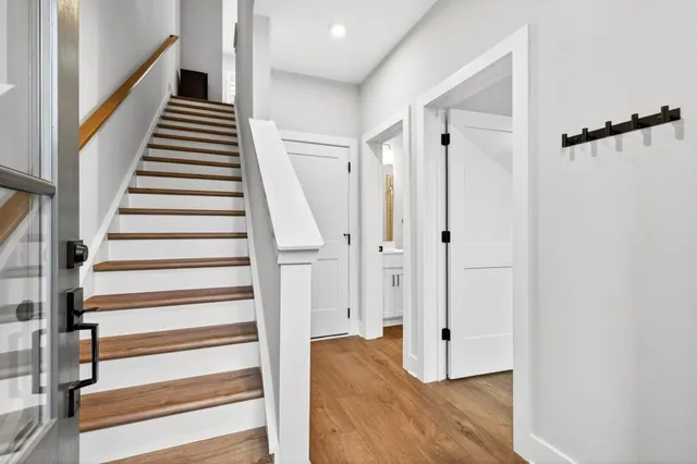 a view of entryway with wooden floor and stairs