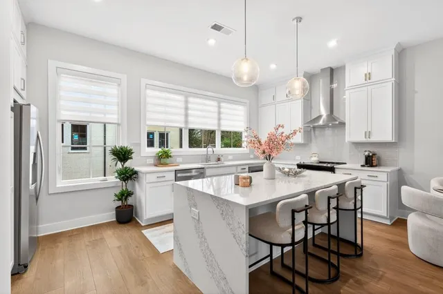 a large kitchen with a table and chairs