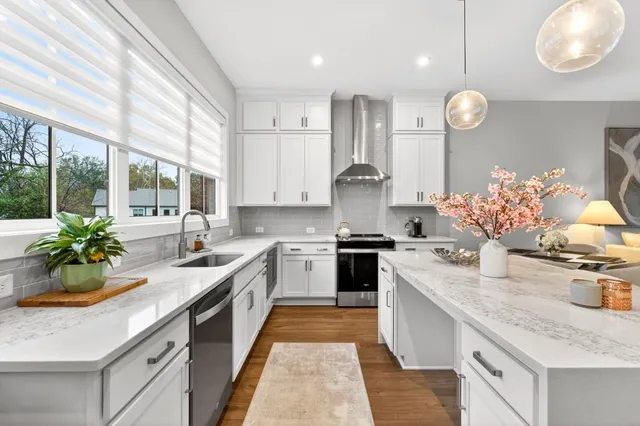 a kitchen with granite countertop a sink stove and cabinets