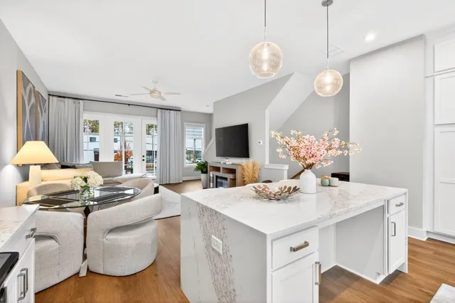 a kitchen with a sink dishwasher a stove a dining table and chairs