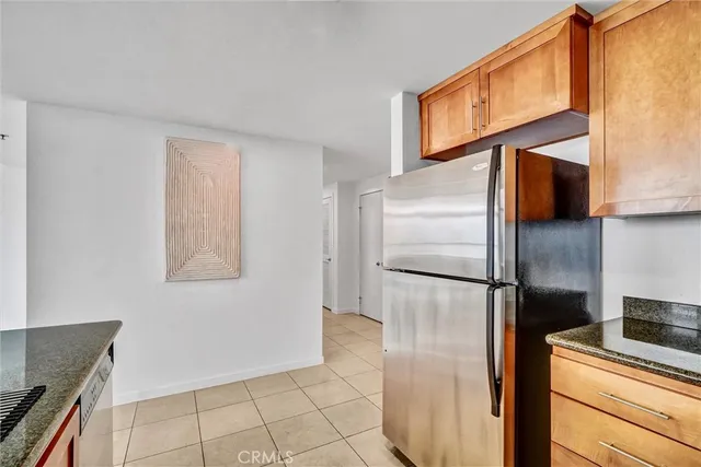 a kitchen with a refrigerator sink and cabinets