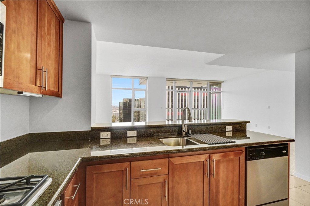 411 West Seaside Way, Unit 1804 Long Beach, CA 90802 - Photo 13 of 55 a kitchen with granite countertop a sink and a stove