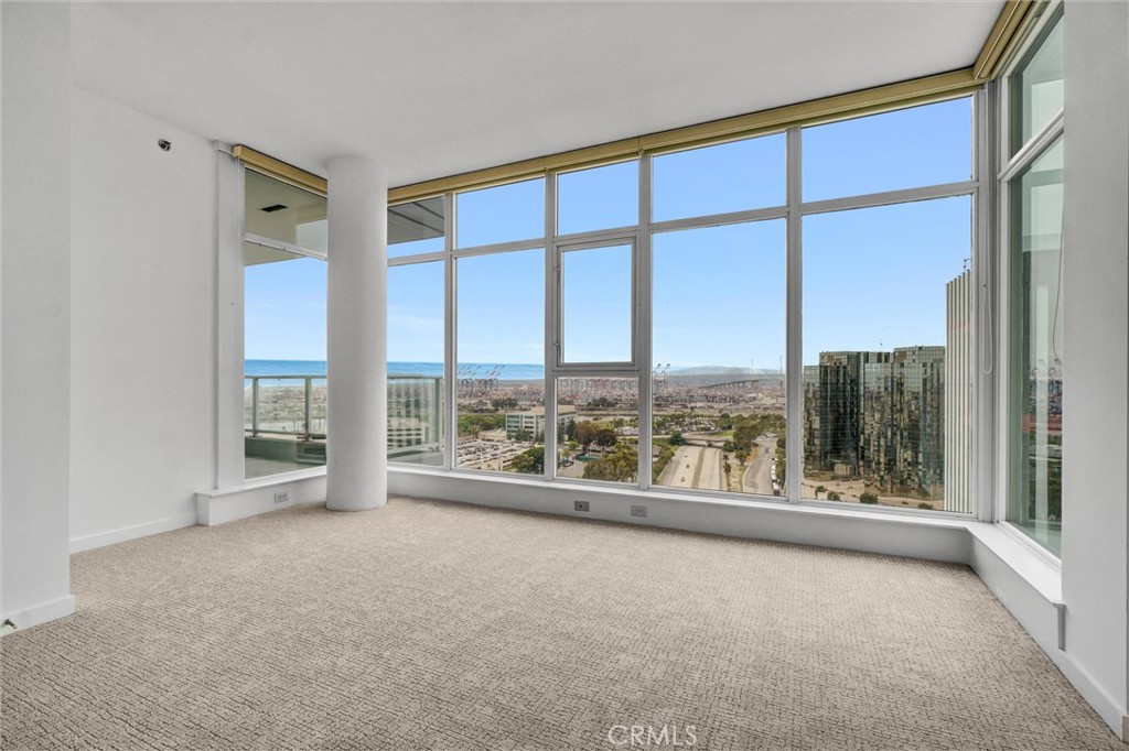 411 West Seaside Way, Unit 1804 Long Beach, CA 90802 - Photo 26 of 55 an empty room with wooden floor and windows