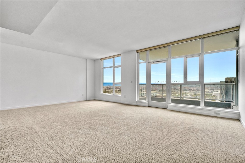 411 West Seaside Way, Unit 1804 Long Beach, CA 90802 - Photo 4 of 55 an empty room with floor to ceiling windows and city view