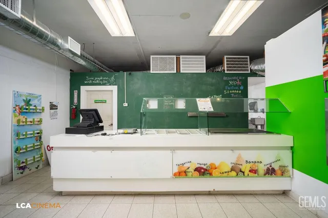 a living room with a table chair and a stove