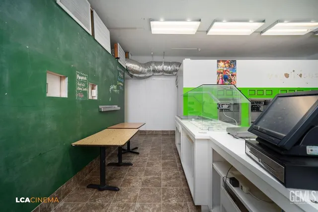a kitchen with stainless steel appliances kitchen island granite countertop a refrigerator and a sink