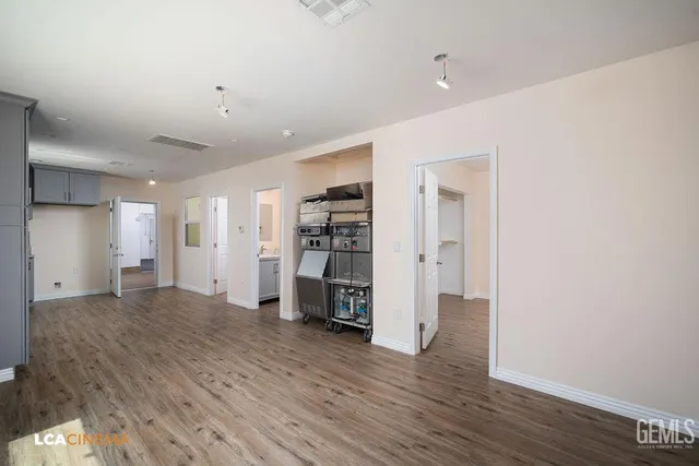 a view of a kitchen with a sink and a refrigerator