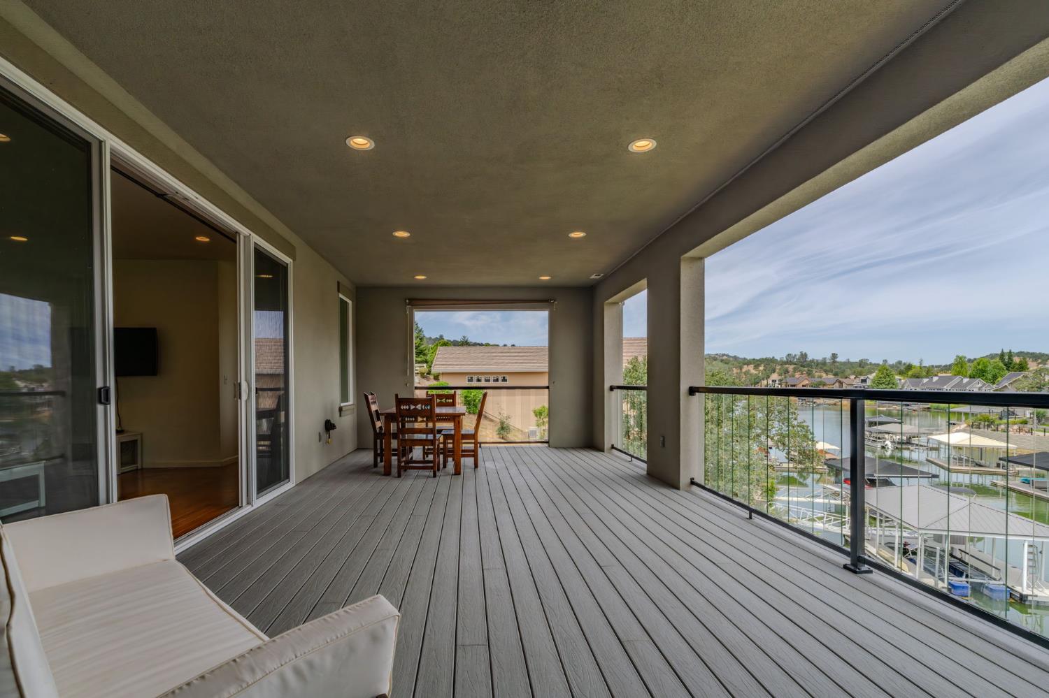 6066 Bluff View Road Copperopolis, CA 95228 - Photo 66 of 96 a view of a balcony with chairs and wooden floor