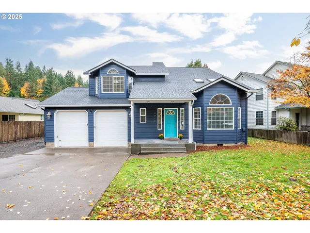 a front view of a house with a garden and yard