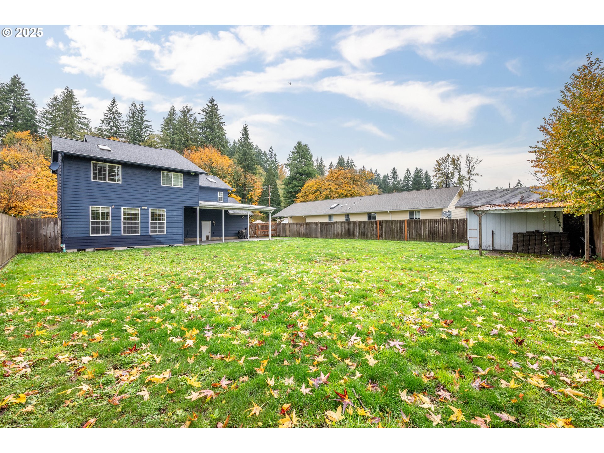 2770 48th Avenue Longview, WA 98632 - Photo 27 of 31 a view of a house with a small yard and a large tree