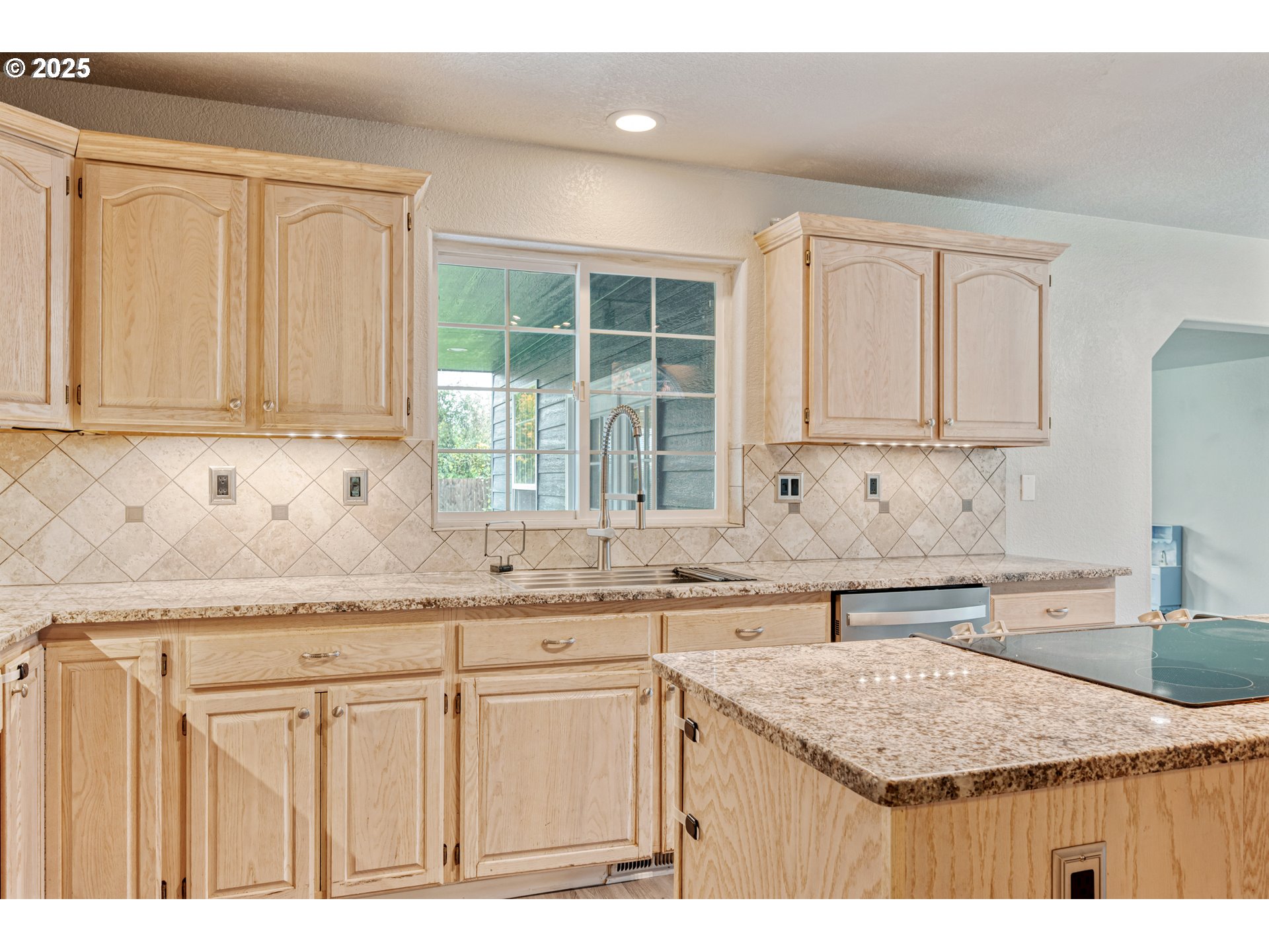 2770 48th Avenue Longview, WA 98632 - Photo 7 of 31 a kitchen with granite countertop a sink stove and cabinets