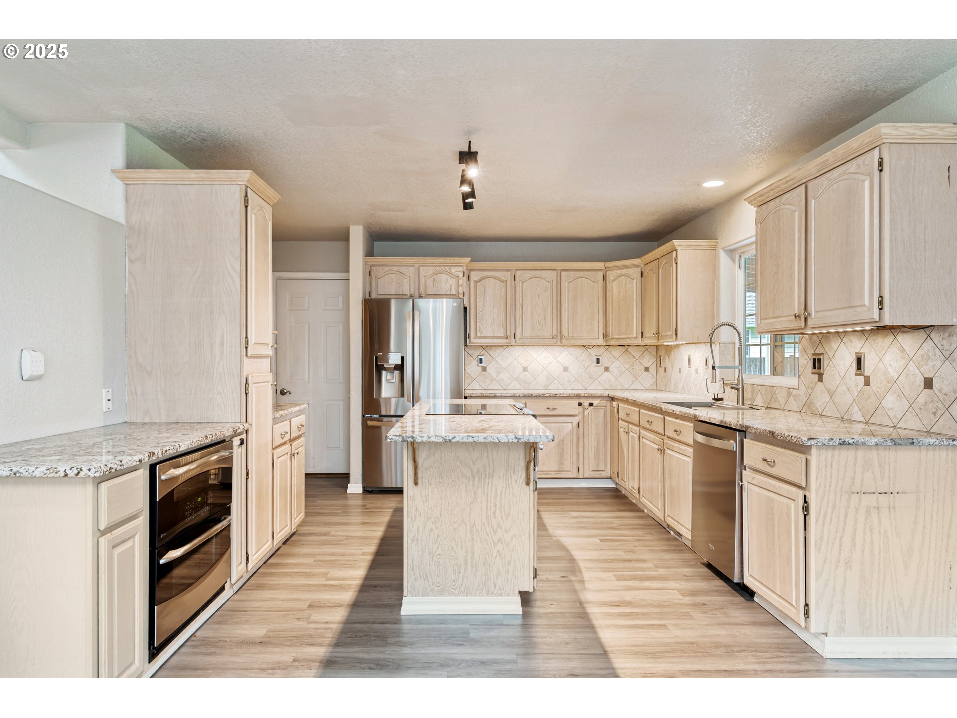 2770 48th Avenue Longview, WA 98632 - Photo 9 of 31 a kitchen with a sink stove top oven and cabinets