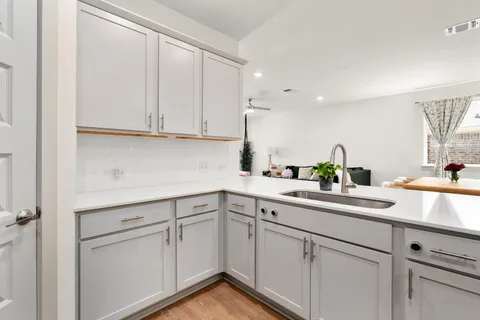 a kitchen with white cabinets and white appliances