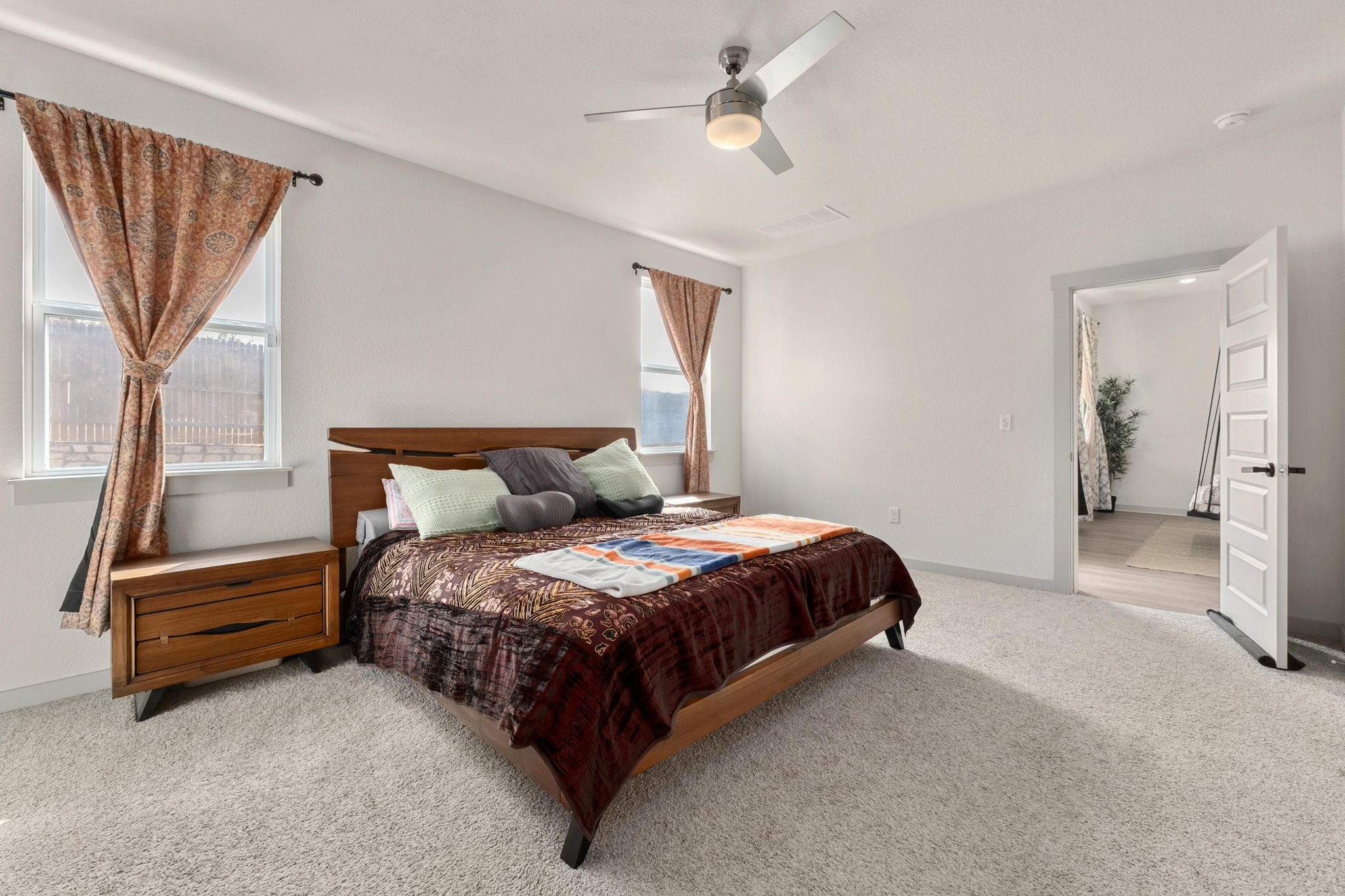 10509 Defender Trail Austin, TX 78754 - Photo 12 of 37 a spacious bedroom with a bed and a chandelier