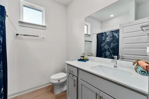 a bathroom with a sink a toilet and mirror