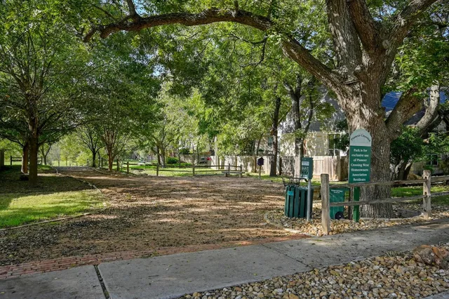 a view of a swimming pool with a bench and wooden fence