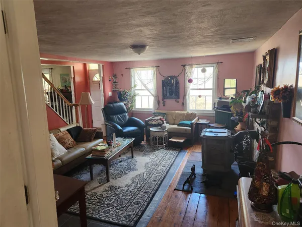a living room with furniture fireplace and a large window