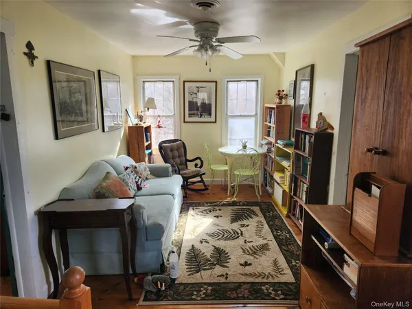 a living room with furniture rug and window