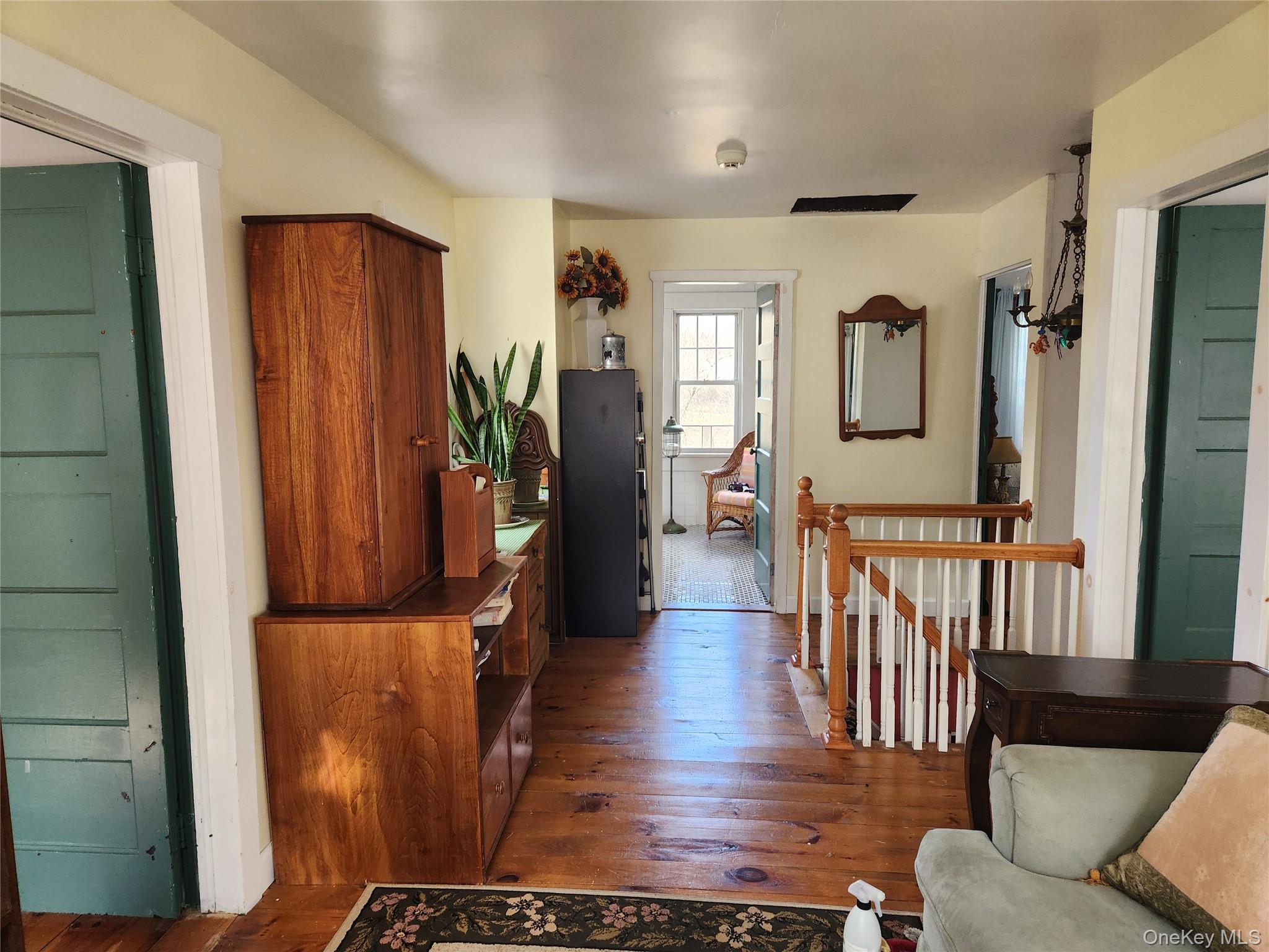 26 Bloody Hill Road Craryville, NY 12521 - Photo 18 of 18 a living room with furniture a wooden floor and a potted plant