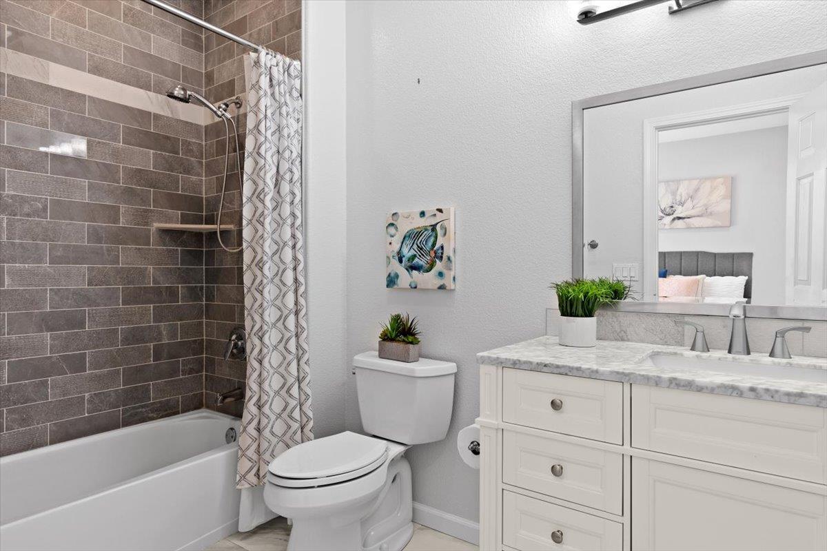 467 Whitechapel Avenue San Jose, CA 95136 - Photo 13 of 34 a bathroom with a sink a toilet a mirror a bathtub and shower