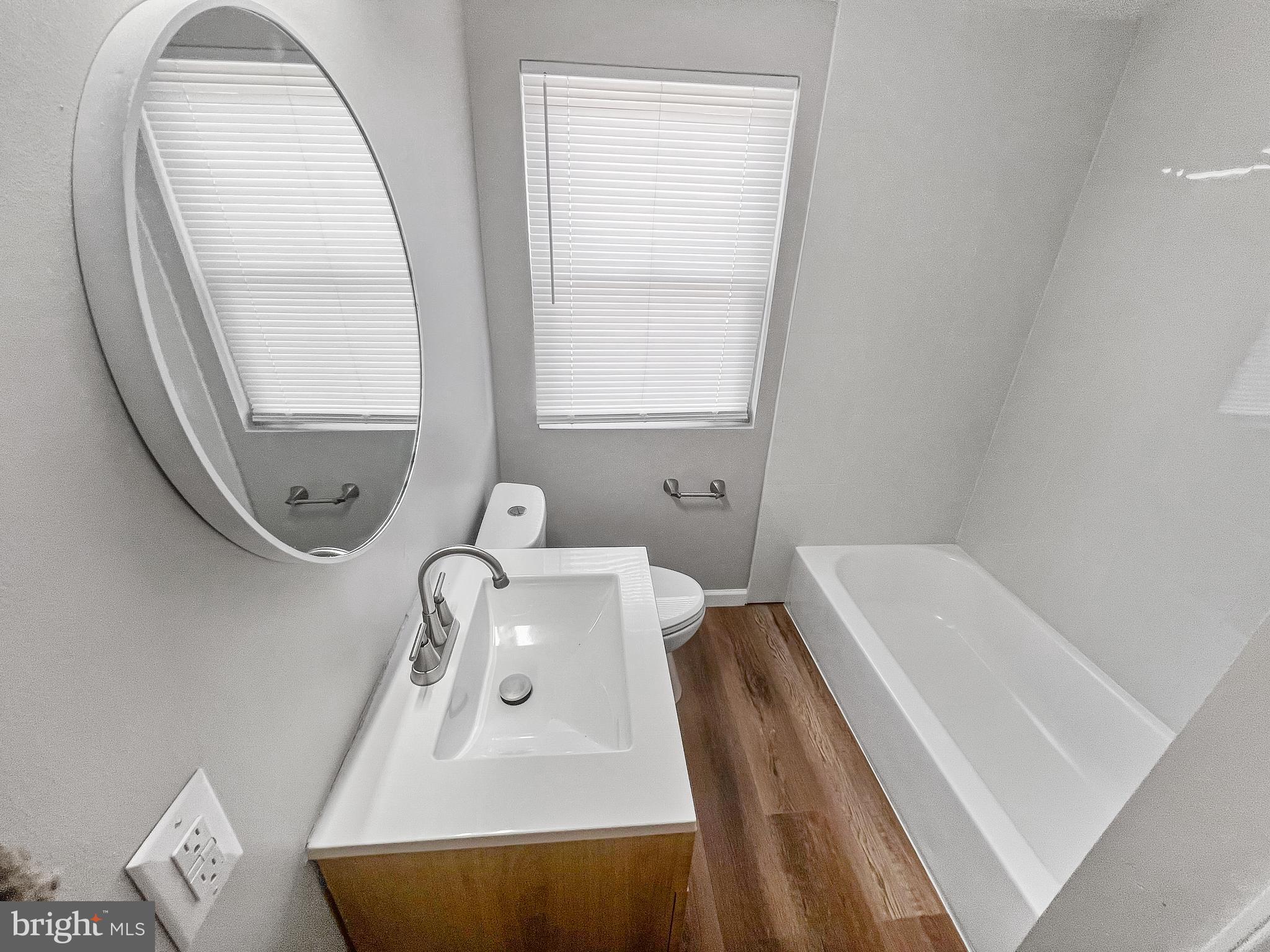 5755 Maplehill Road Baltimore, MD 21239 - Photo 7 of 9 a bathroom with a bathtub sink and mirror