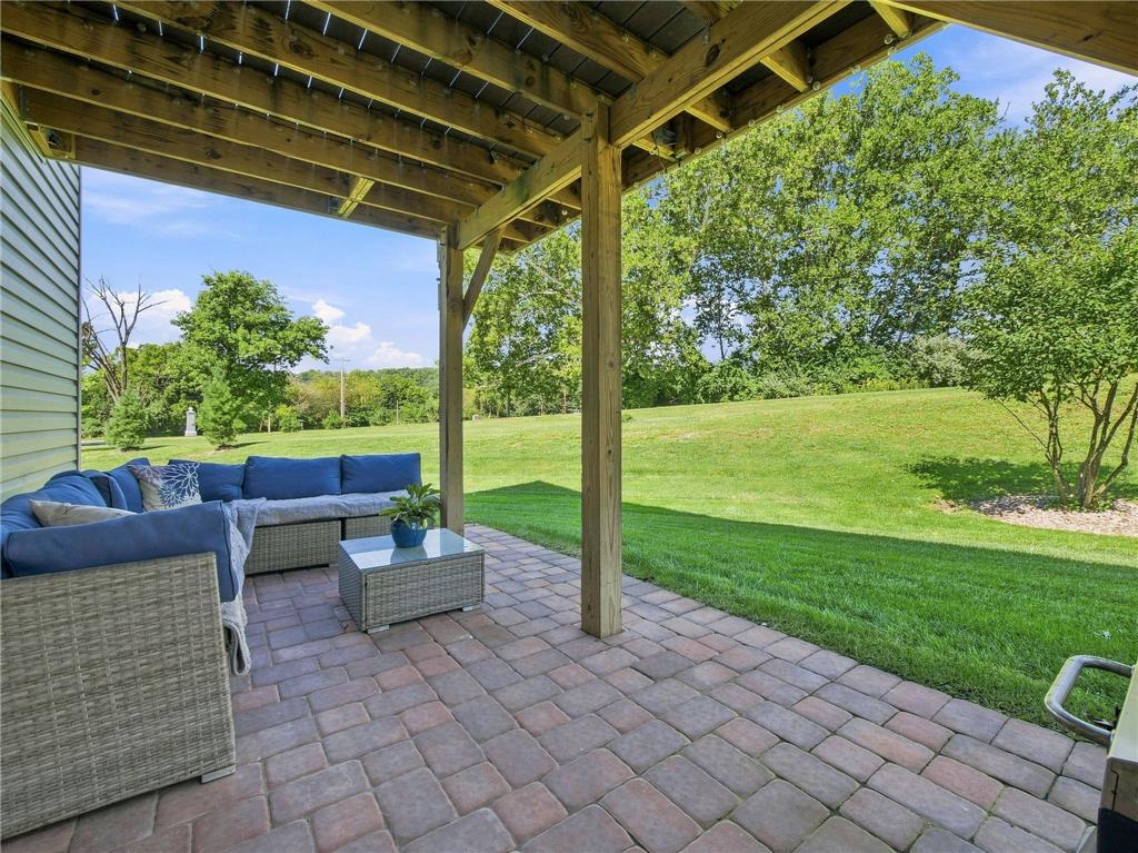 2133 Cross Country Road Northampton, PA 18067 - Photo 10 of 44 An inviting covered paver patio looks out over a rolling, tree-lined green lawn.