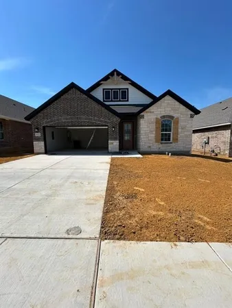 a front view of a house with yard