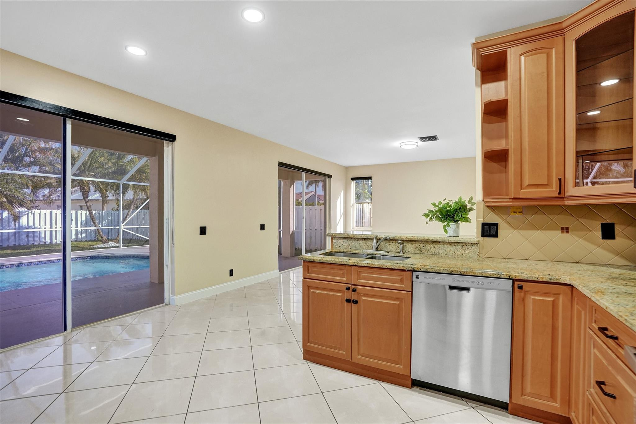 574 Slippery Rock Road Weston, FL 33327 - Photo 14 of 64 a kitchen with a sink and cabinets