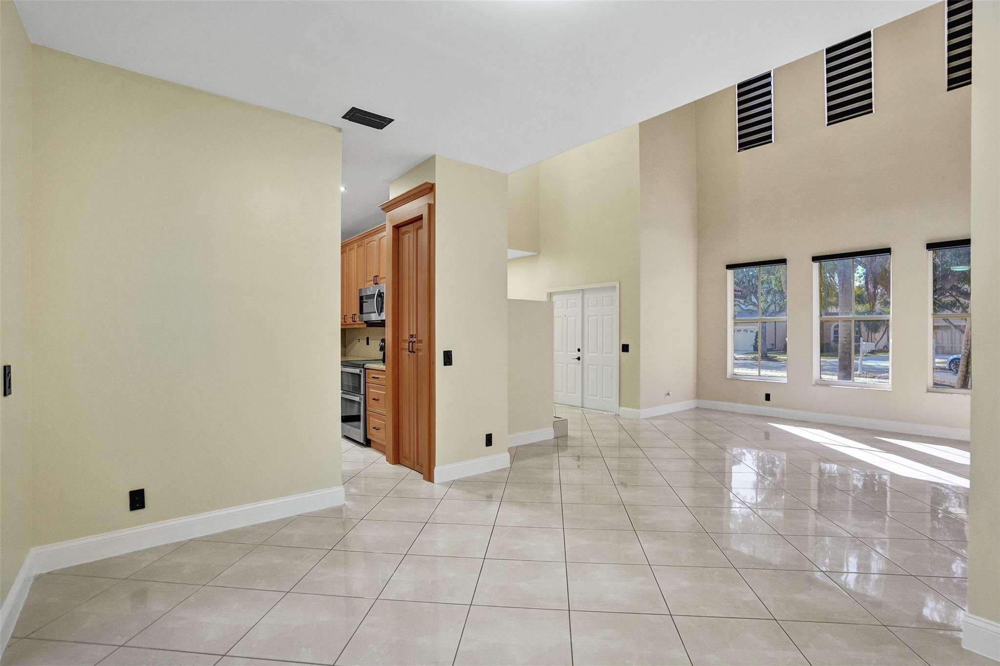 574 Slippery Rock Road Weston, FL 33327 - Photo 24 of 64 a view of an empty room with window and wooden floor